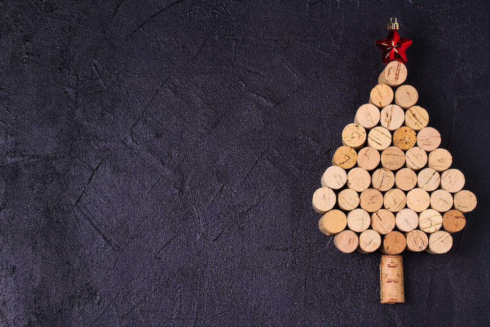 Christmas tree made of  wine corks. Mockup, layout, flat lay. New Year winter season concept, background